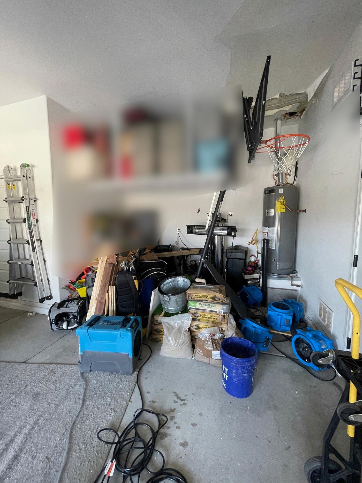 Water-stained, sagging drywall in the garage ceiling.