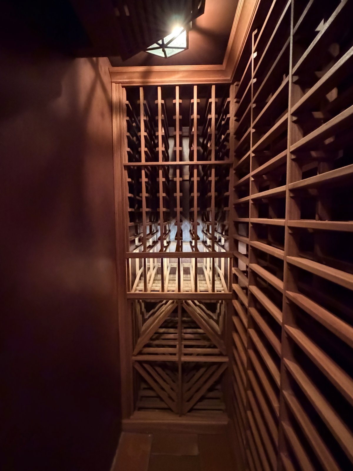 Custom built-in hardwood wine rack preserved intact during Category 3 water damage mitigation